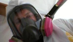 Water Damage Restoration Technician With Gas Mask